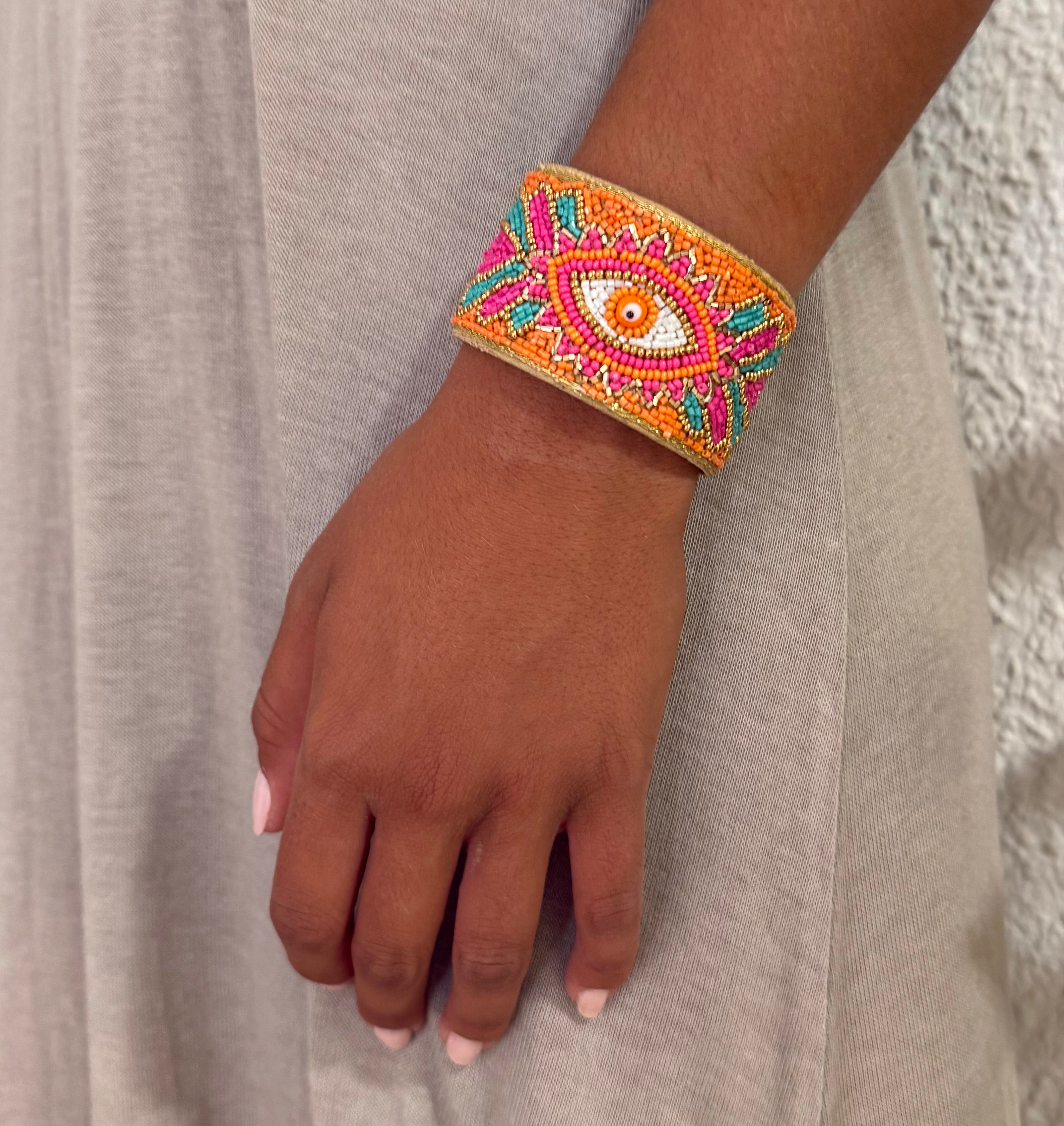 Brazalete "Occhio" naranja y fucsia